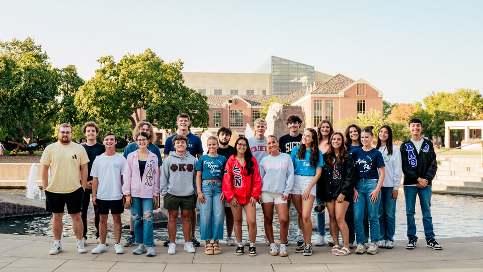 Fraternity and sorority members pose as group at Broyhill Fountain.